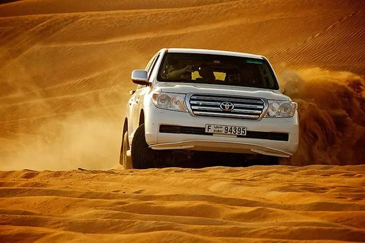 Dubai dune bashing guide showing professional 4x4 desert driving